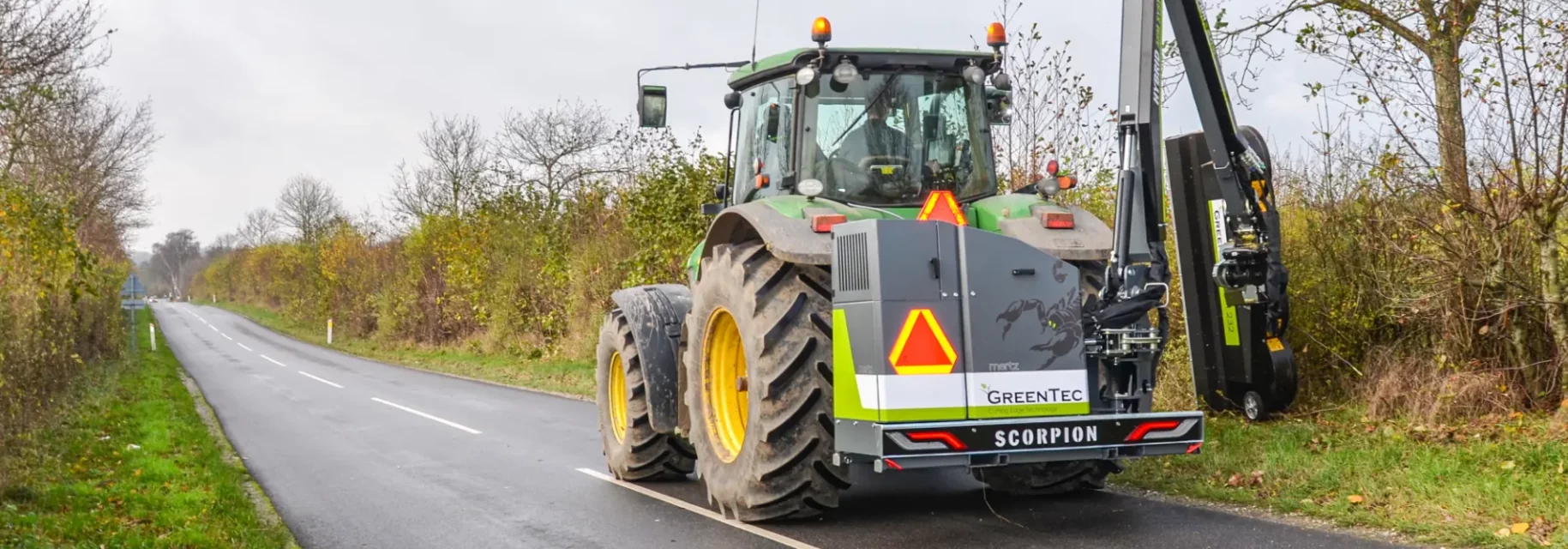 Boom mower mounted on tractor