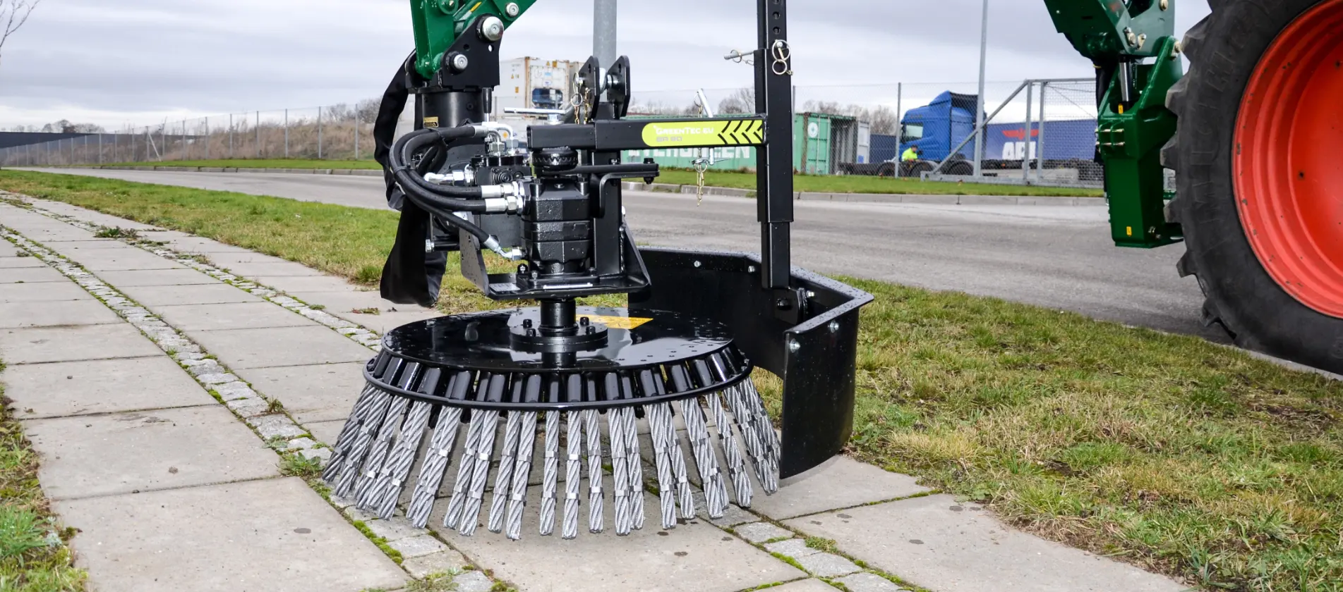 Road brush mounted on tractor