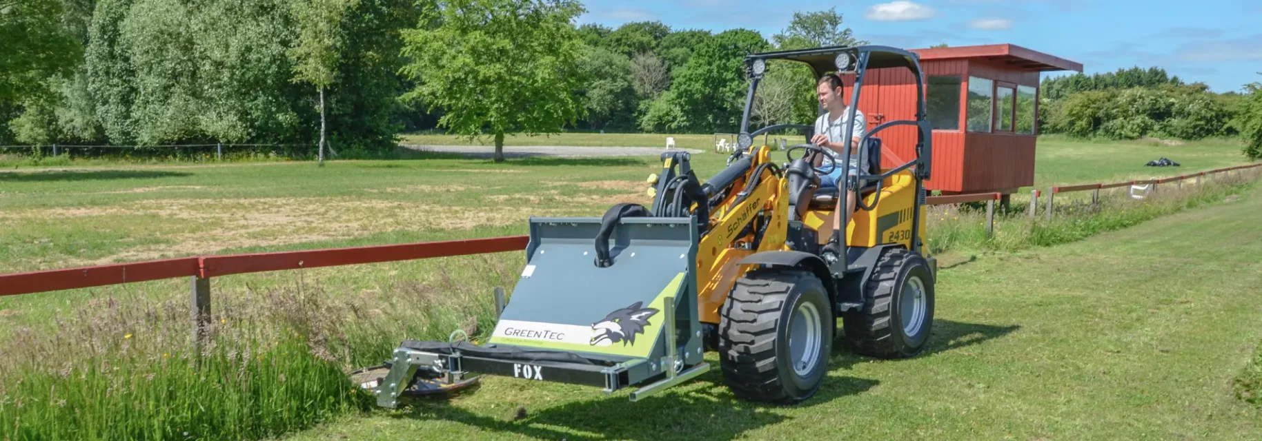 Under fence mower for skid steer loader