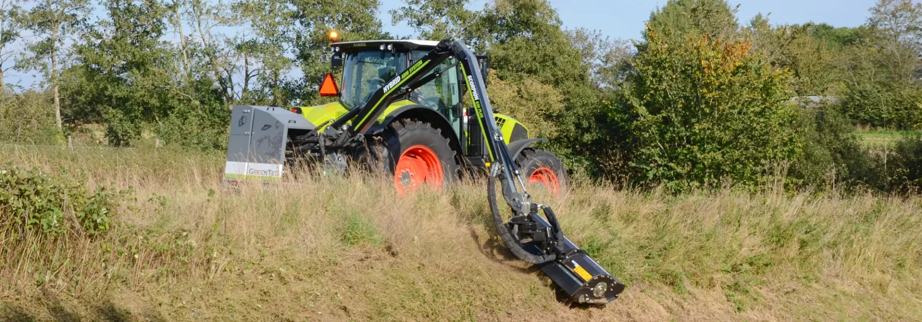 Grass being mowed on a slope with a tractor