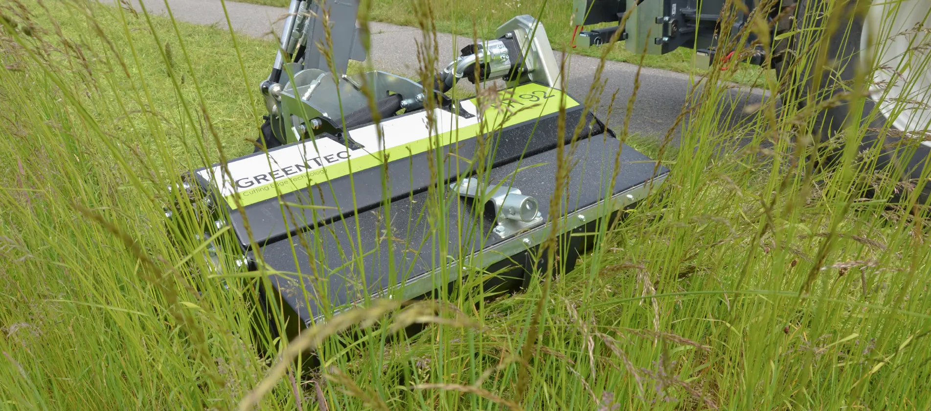 Professional brush cutter attachment for maintenance of green areas