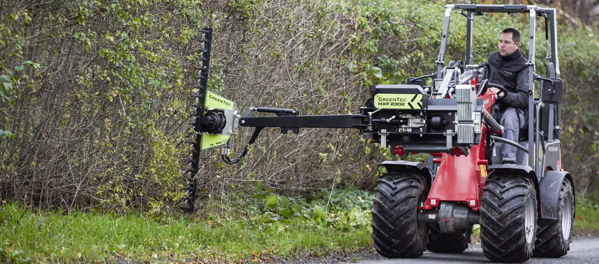 Skid steer loader with hedge cutter attachment