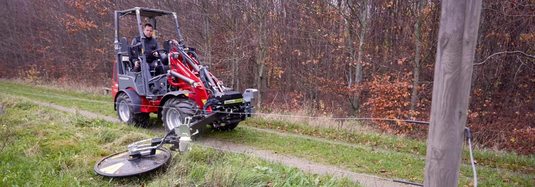 Fence mower attachment for skid steer loader