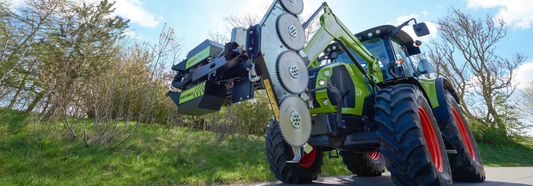 Front end loader attachment for tree trimming