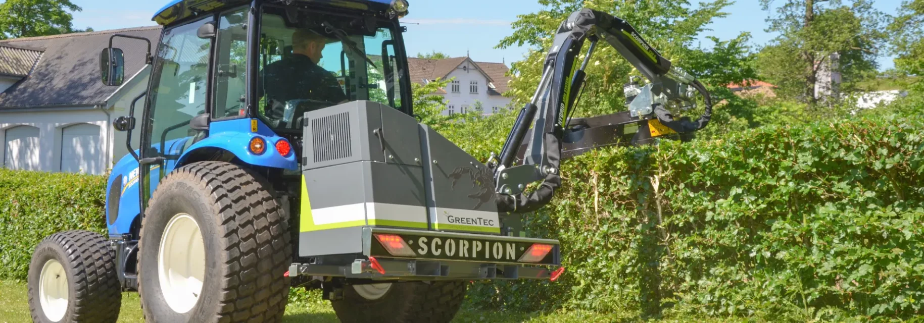 Small tractor with hedge trimmer attachment