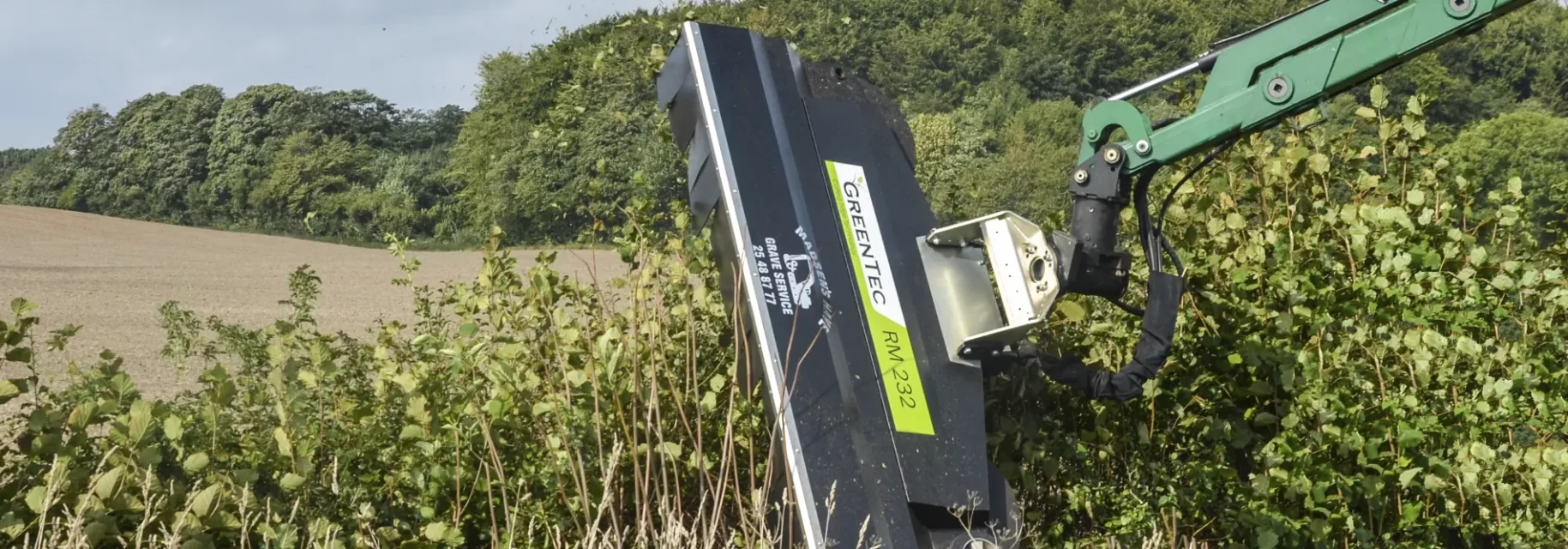 Hedge mulcher crushing twigs and leaves