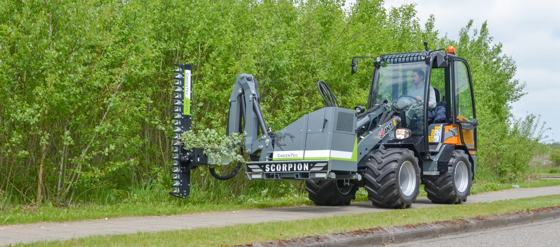 Mini boom mower trims trees
