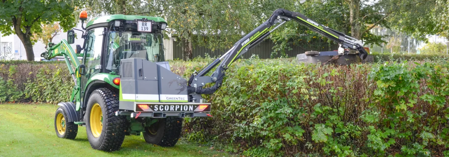 Professional hedge trimming with boom mower arm