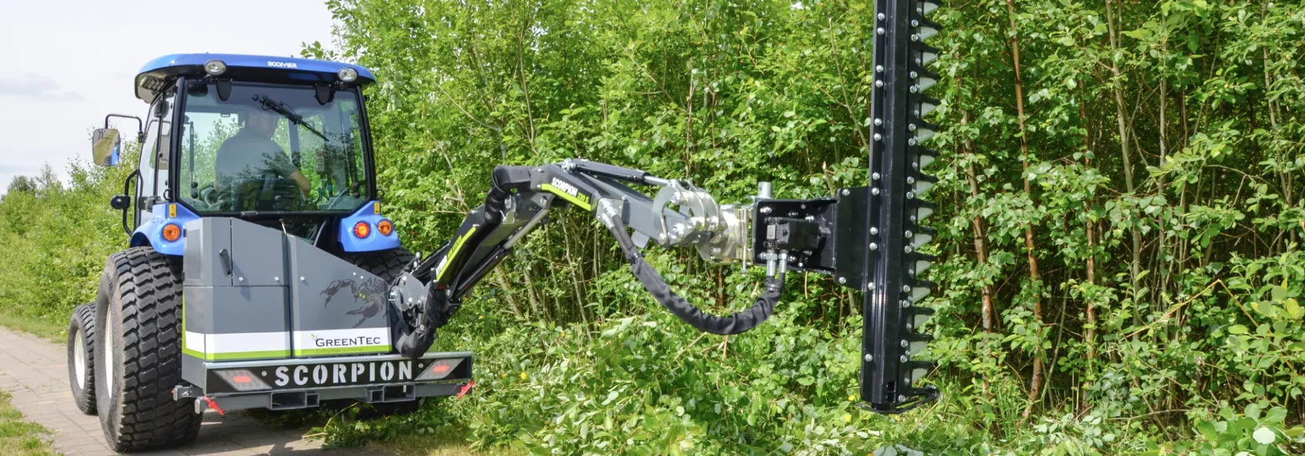 Boom mower with hedge trimmer attachment