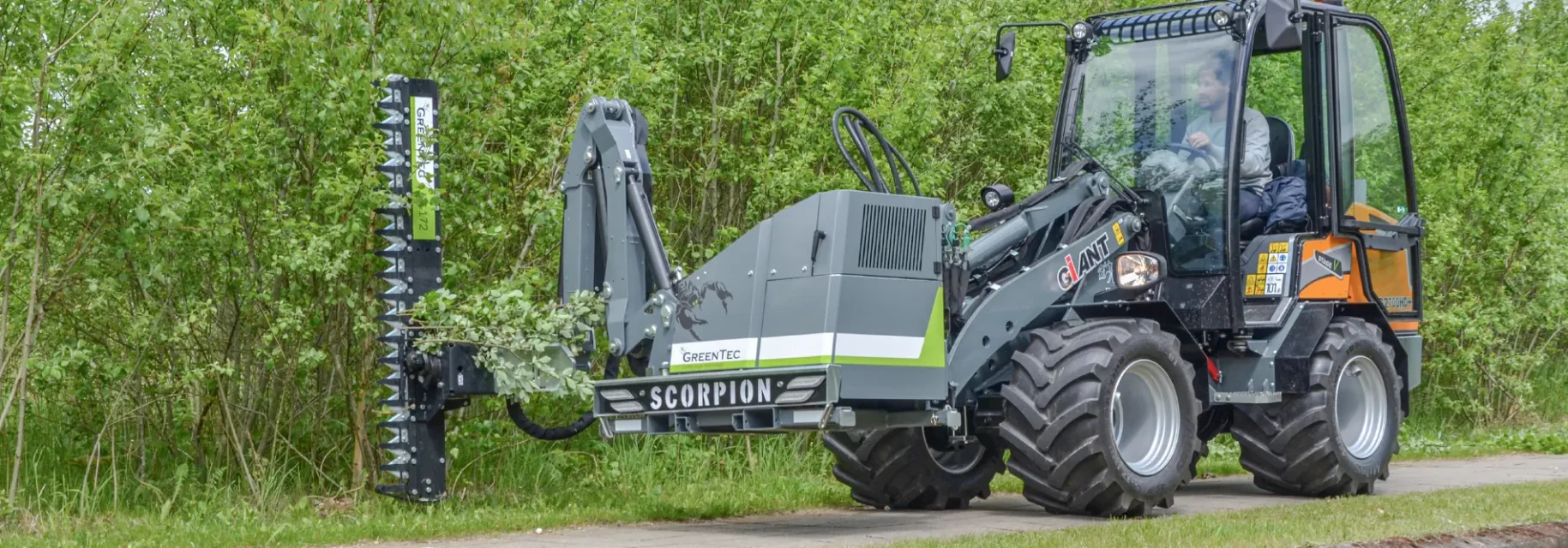 Professional boom mower mounted on skid steer loader