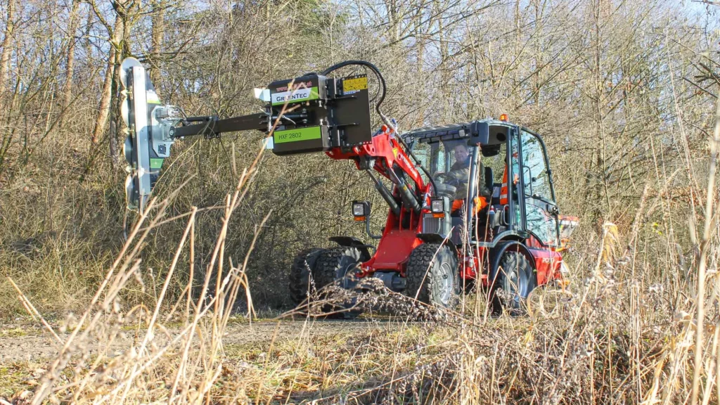 Hedge trimming equipment for skid steer loader
