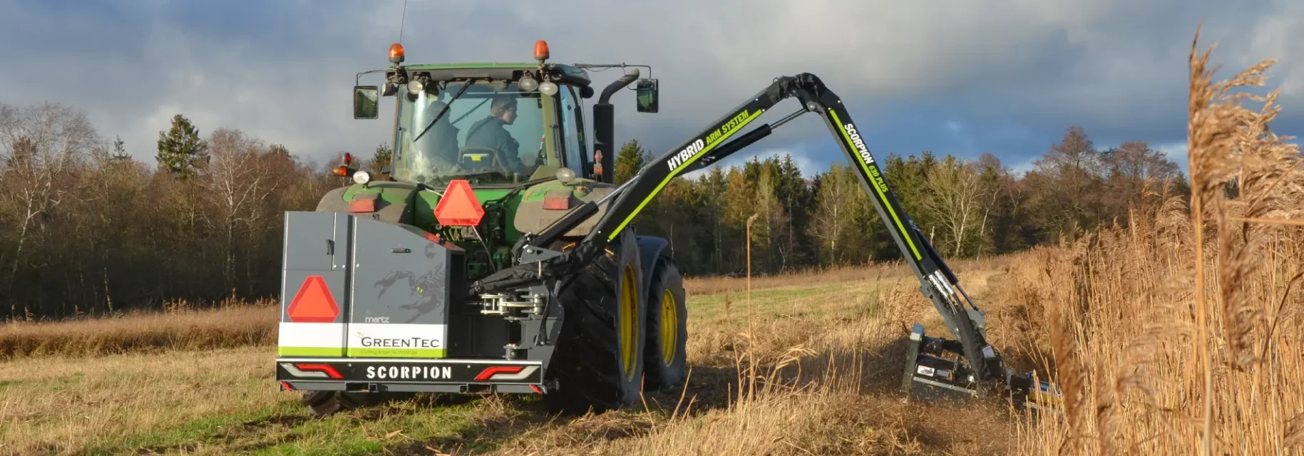 Tractor mounted mower on a field