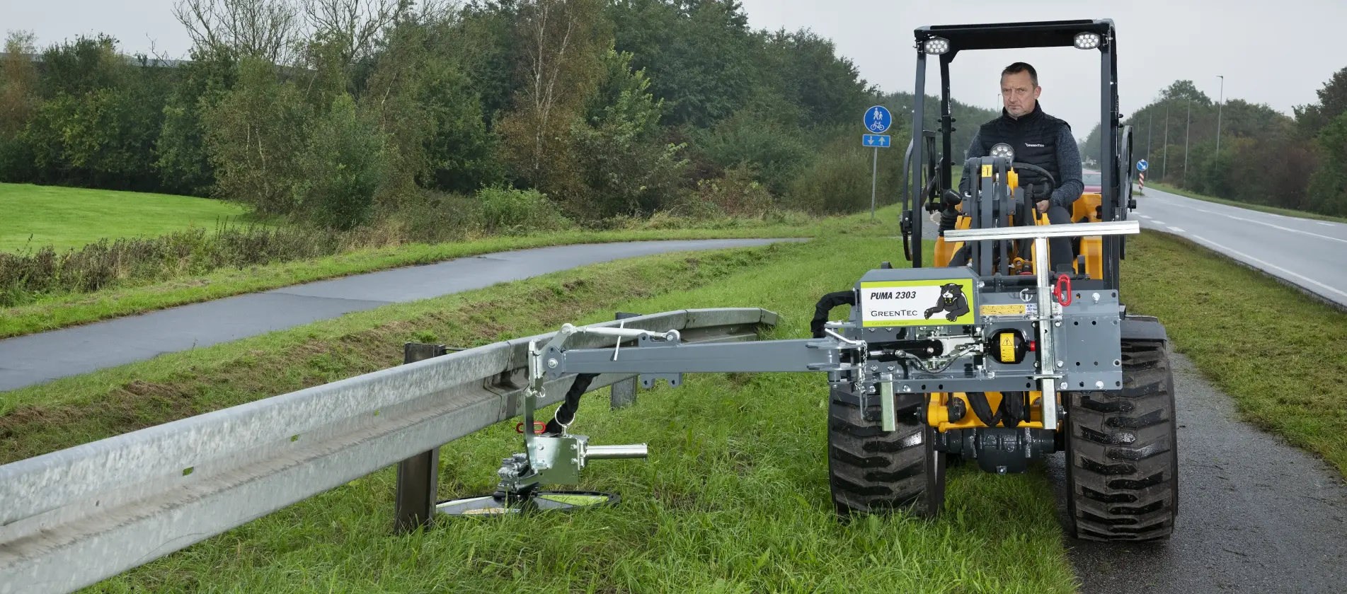 Guardrail mowing with skid steer loader