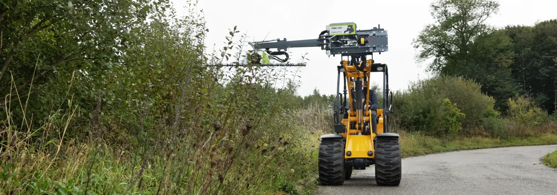 Hedge trimming with skid steer loader