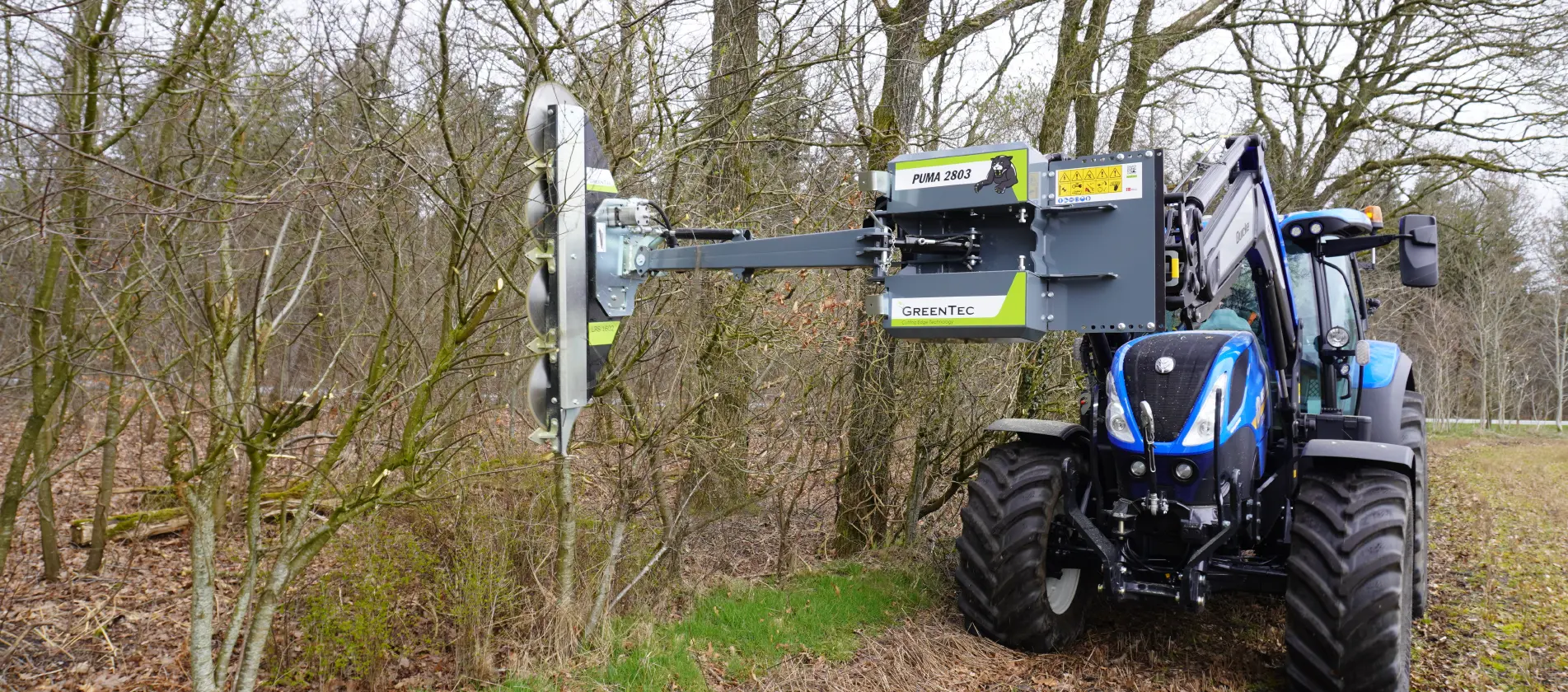 Hydraulic saw attachment mounted on front end loader