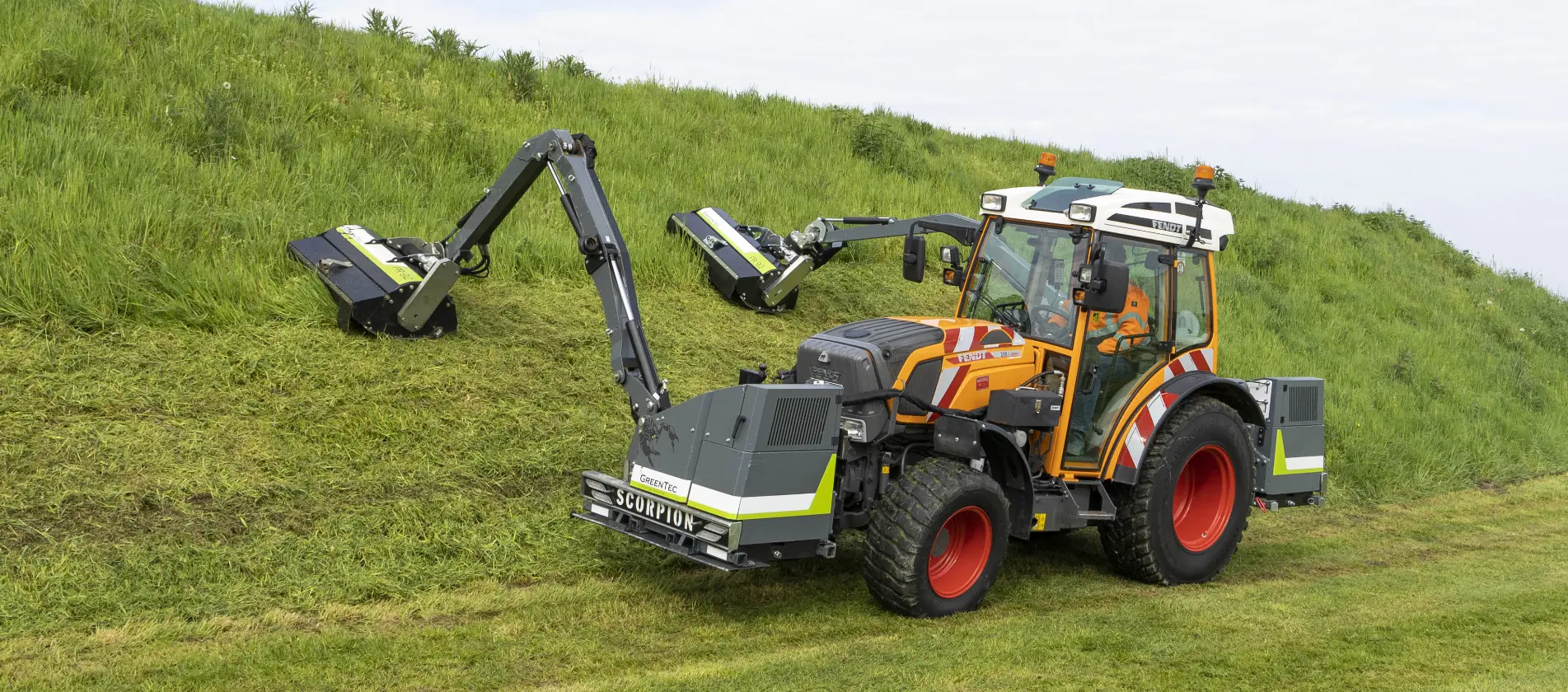 Boom mowers mounted on a small tractor