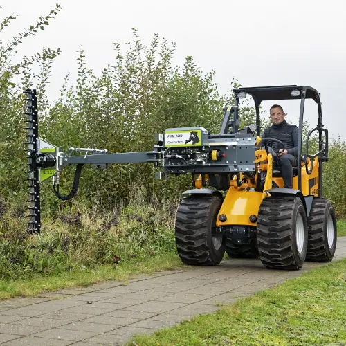 Municipal worker maintaining hedge near road
