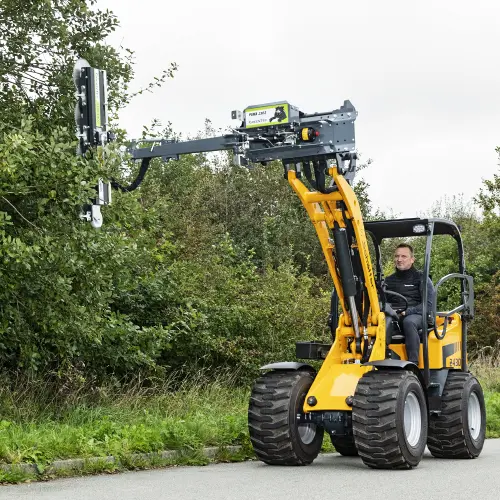 Prune branches on narrow roads with a small loader
