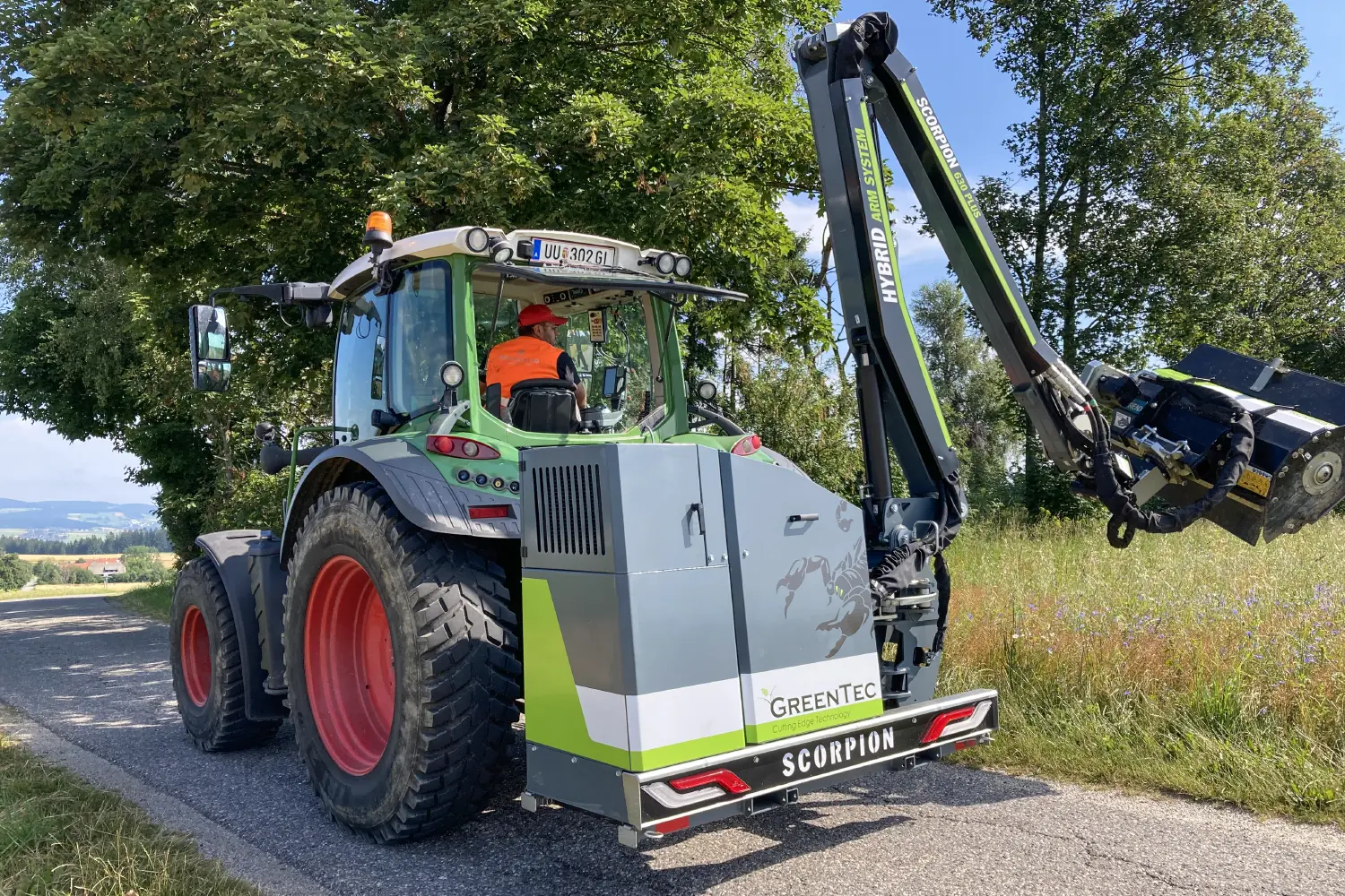 Boom mower rear mounted on tractor